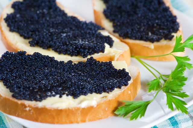 Black caviar on a slice of bread and butter